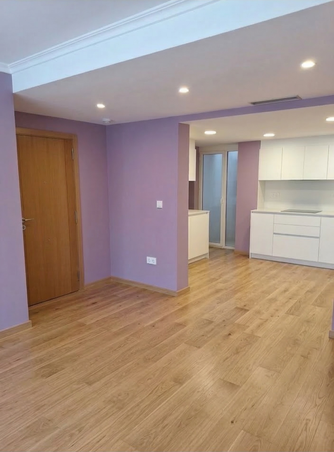Living room and open kitchen after interior repaint with a clean matte finish.