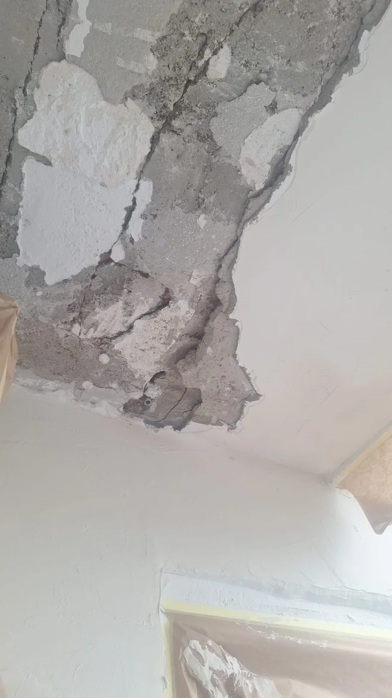 Close-up of ceiling humidity damage before repair.
